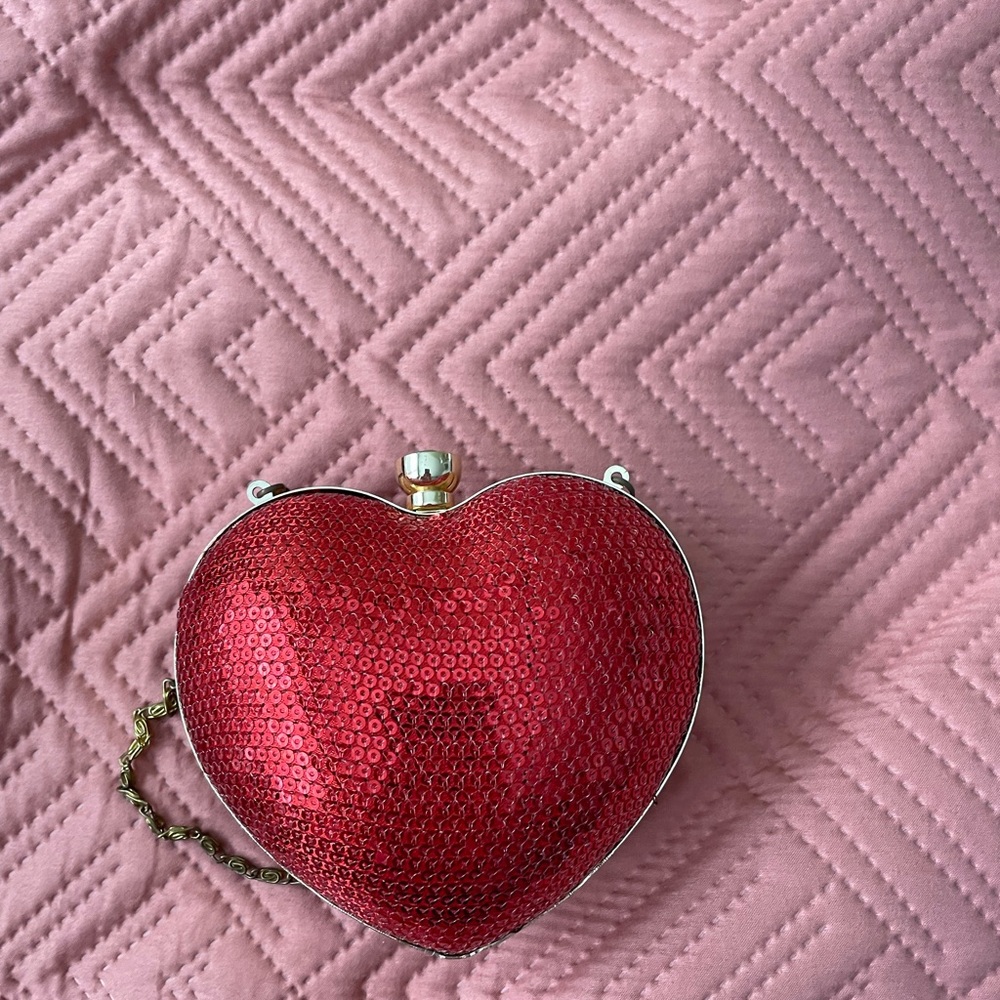Heart-shaped clutch with attachable strep.